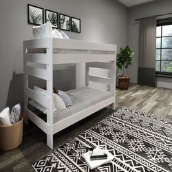 Bunk bed in modern bedroom with gray walls, wooden floor, and tribal pattern rug.