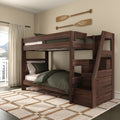 Rustic wooden bunk bed with ladder and green bedding beneath decorative wooden oars in a cozy sunlit bedroom with plaid rug