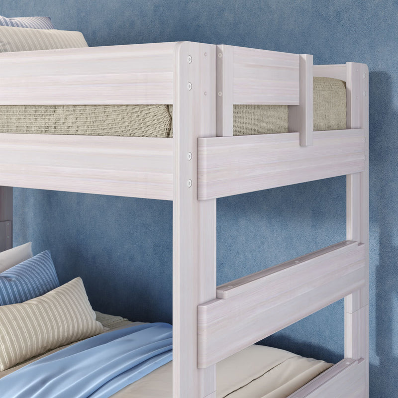 Whitewashed solid wood twin-over-twin bunk bed with guardrails, blue bedding and striped pillows in a modern kids' bedroom, space-saving sturdy design