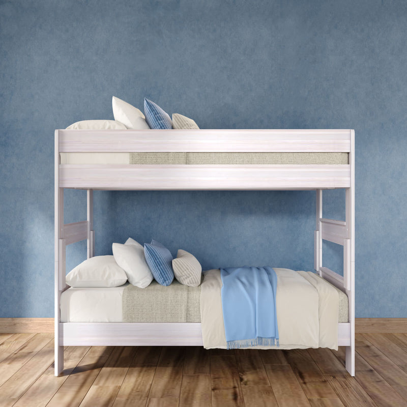 White wooden bunk bed with blue and beige bedding in a modern children's bedroom — space-saving design on hardwood floor against a textured blue wall