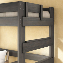 Close-up of gray solid wood twin bunk bed frame with guardrails and mattress against beige wall, modern bedroom style