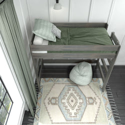 Loft bed with green bedding and decorative rug in modern bedroom design.