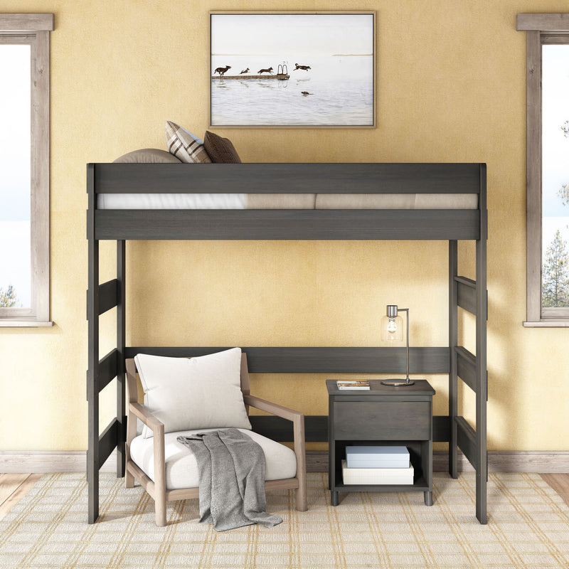 Modern dark wood twin loft bed over a cozy reading nook with white armchair, gray throw, nightstand and lamp against sunny yellow walls