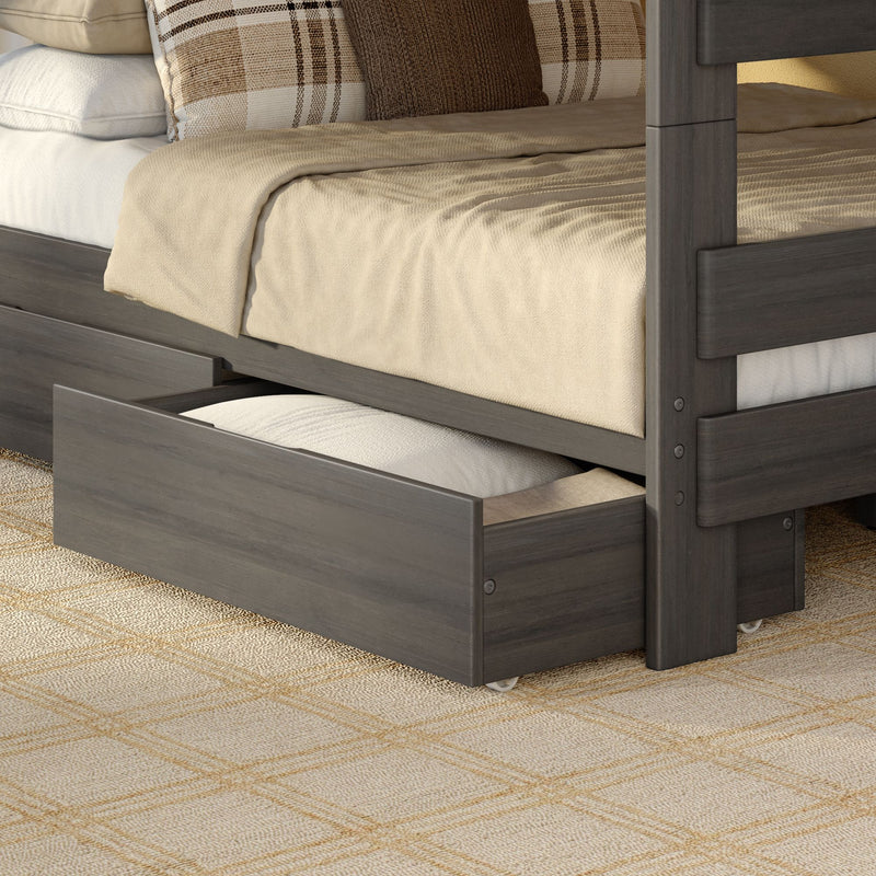 Gray wooden trundle bed with beige bedding and plaid accent pillows, open under-bed storage drawer for small bedrooms