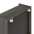 Dark wood cabinet top with white nylon sliding-door roller and metal mounting brackets against a black interior panel