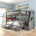 Gray wooden loft bunk bed with under-bed pull-out storage drawers, built-in ladder and coastal paddle wall decor on a blue bedroom wall