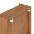 Close-up of oak sliding door top showing white nylon roller wheel, metal mounting brackets, and recessed screw