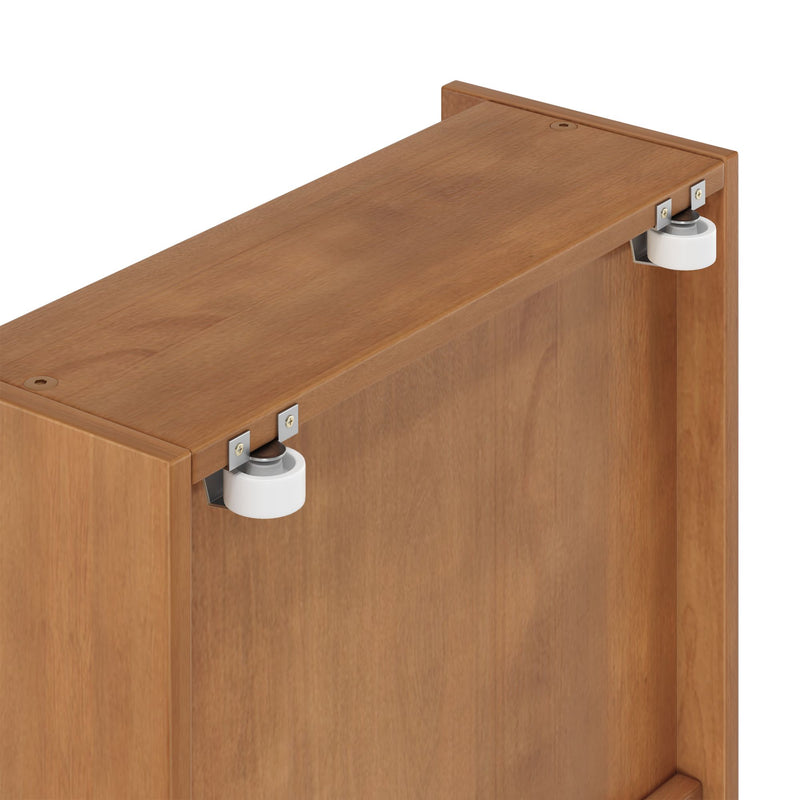 Close-up of oak sliding door top showing white nylon roller wheel, metal mounting brackets, and recessed screw