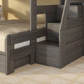 Gray wooden bunk bed with built-in storage stairs and drawers, beige bedding and plaid accent pillow in a modern kids' bedroom