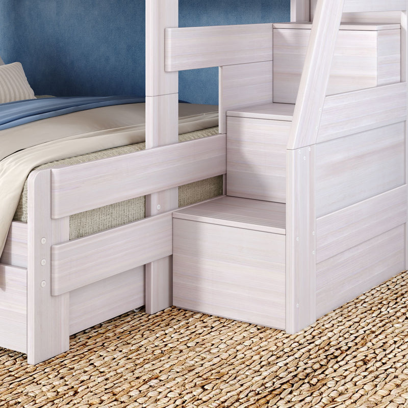 Whitewashed wooden bunk bed with built-in storage stairs, blue bedding and woven jute rug in a modern kids' bedroom