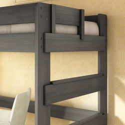 Close-up of modern gray wooden loft bunk bed frame with safety guardrails and visible hardware, upper mattress and study area with chair below