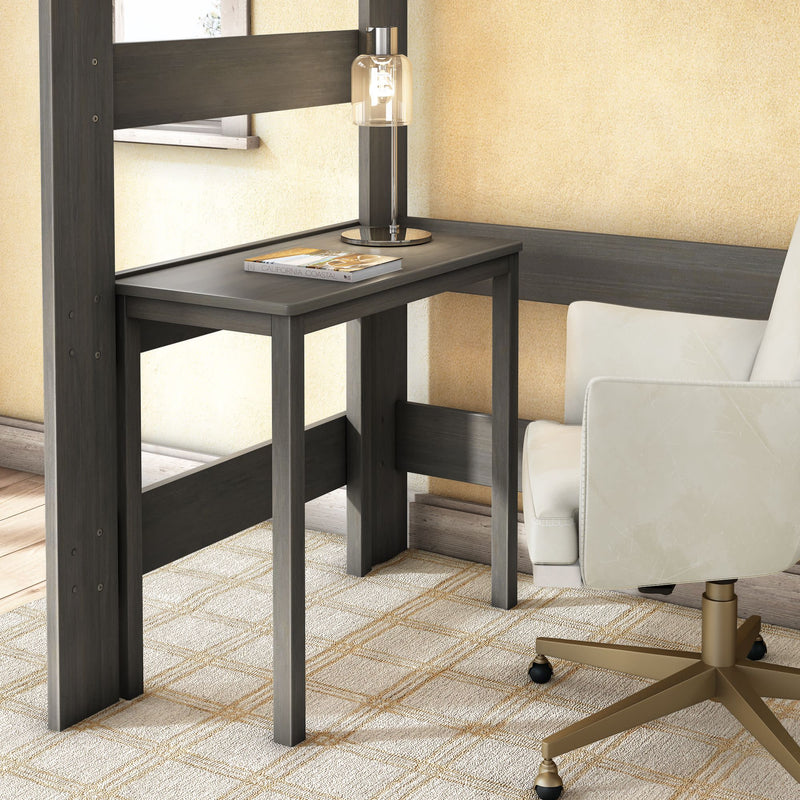 Modern dark gray wooden corner desk in a cozy home office nook with a glass table lamp and magazine on top, paired with a white swivel office chair with brass base on a beige patterned rug and textured walls.