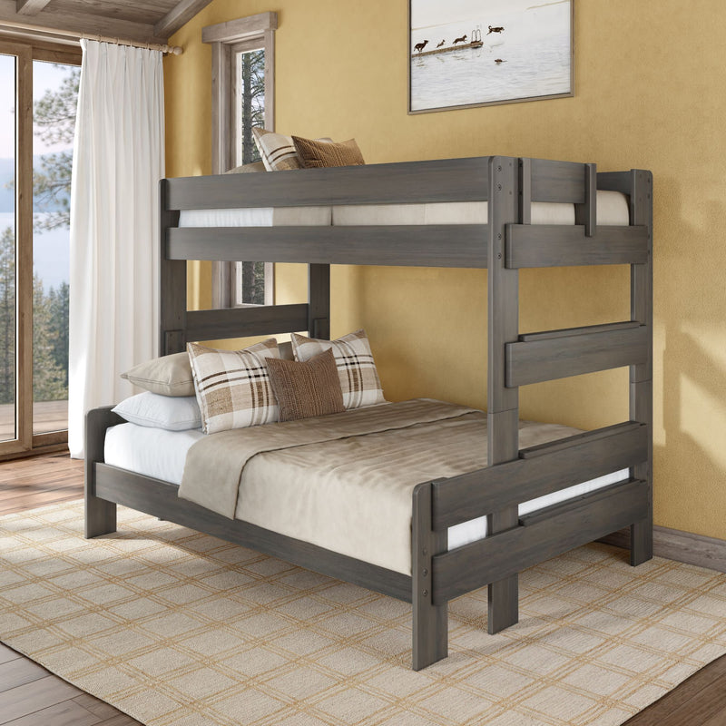 Gray wooden twin-over-full bunk bed in a cozy rustic bedroom with beige bedding and plaid pillows, large window with lake view — ideal space-saving kids and guest room