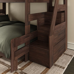 Dark walnut wooden bunk bed with integrated staircase and built-in storage drawers, space-saving modern kids bedroom furniture with green bedding and woven area rug