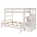 Whitewashed wooden bunk bed with built-in staircase storage and slatted lower platform, space-saving kids bedroom furniture