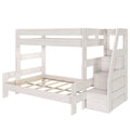 White wooden kids bunk bed (twin-over-full) with built-in storage staircase, guardrails, and slatted lower bed frame for space-saving bedrooms