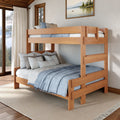Solid wood full-over-twin bunk bed with blue bedding in a cozy mountain-cabin bedroom featuring large windows and natural light