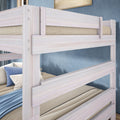 Whitewashed solid wood twin-over-twin bunk bed with safety rails, neutral bedding and blue accent pillows in a modern coastal kids bedroom