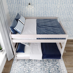 Modern double bunk bed with blue and white bedding in a stylish room.