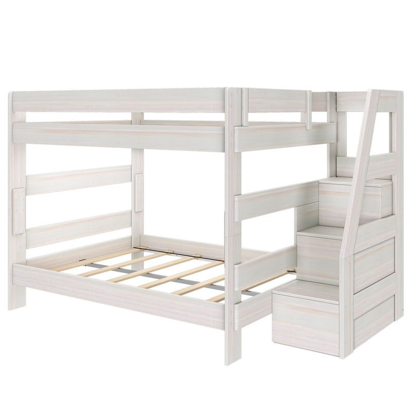 Whitewashed wood twin-over-full bunk bed with built-in storage staircase, guardrails and slatted platform frame — space-saving kids' bedroom solution
