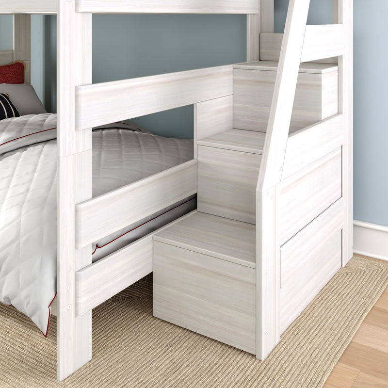 Modern white wooden bunk bed with built-in storage staircase, gray quilted bedding, blue wall and woven rug
