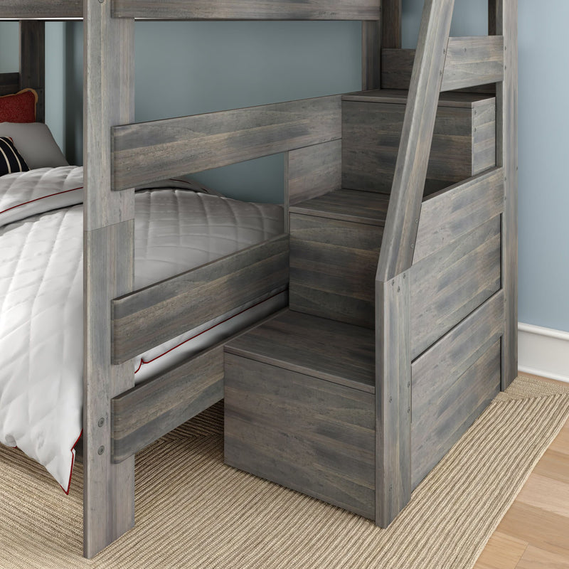 Modern gray wood bunk bed with built-in staircase storage drawers, white quilted bedding with red trim, beige rug and light blue bedroom wall