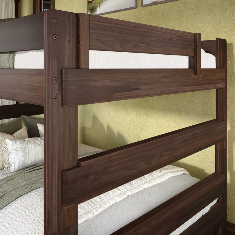 Dark walnut wood bunk bed with horizontal guardrails, white quilted bedding and green accent pillows against a pale green bedroom wall