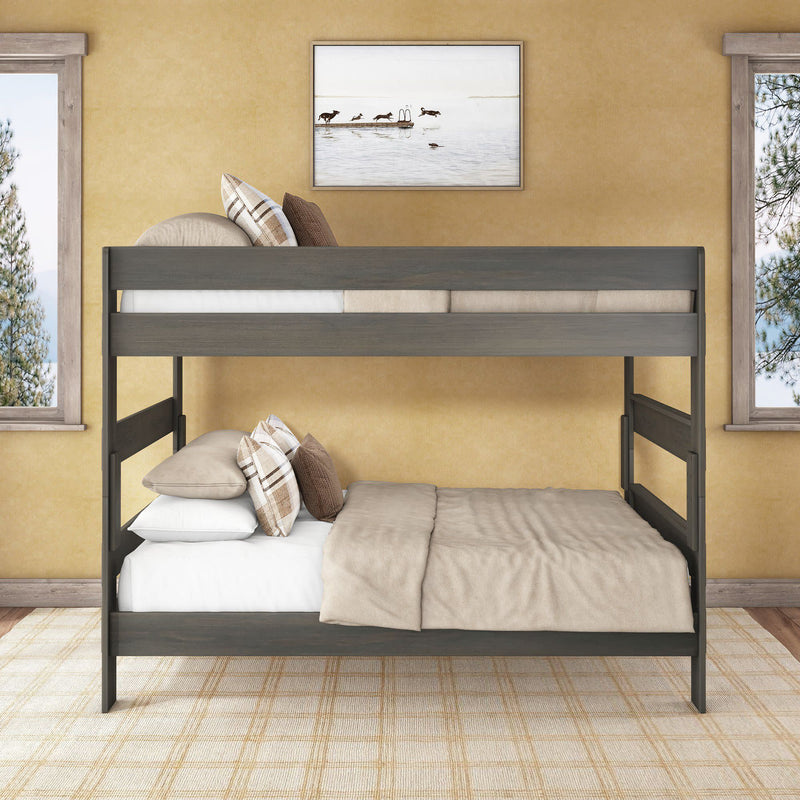 Gray wooden twin-over-full bunk bed with beige bedding and plaid pillows in a cozy neutral bedroom with framed wall art and windows