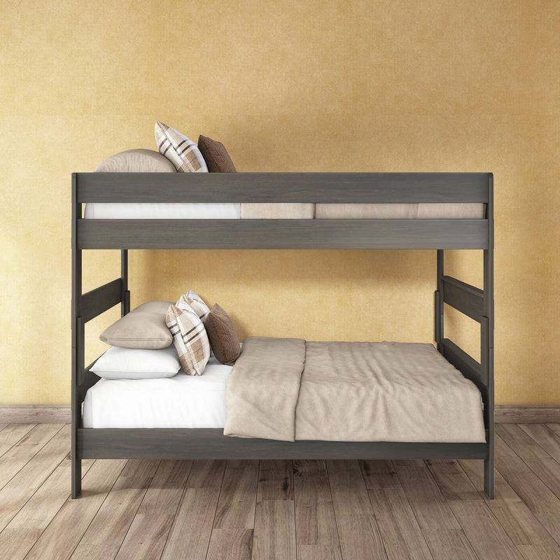 Gray wooden bunk bed with beige bedding and plaid pillows in a modern bedroom against a yellow textured wall and wood plank floor.