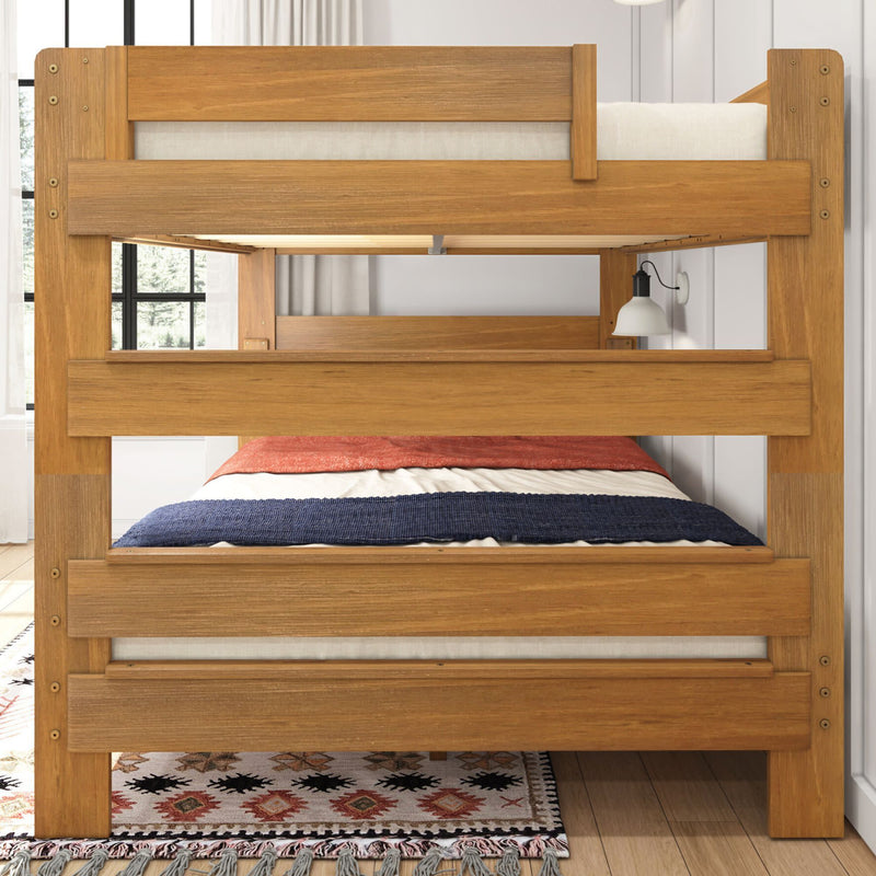 Wooden bunk bed with colorful bedding and a stylish area rug in a bright bedroom.