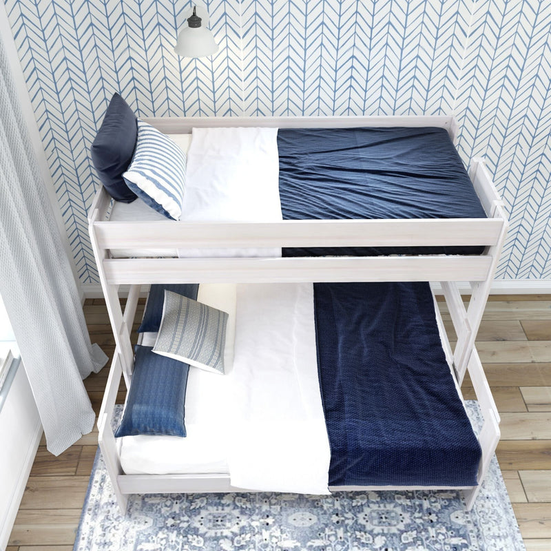 Modern white wood bunk bed with navy blue bedding in a cozy bedroom.