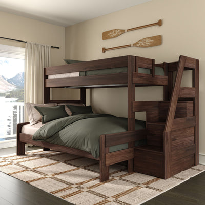Dark walnut wooden bunk bed with integrated storage stairs and olive-green bedding in a cozy rustic bedroom with decorative oars on the wall and a mountain lake view through the window