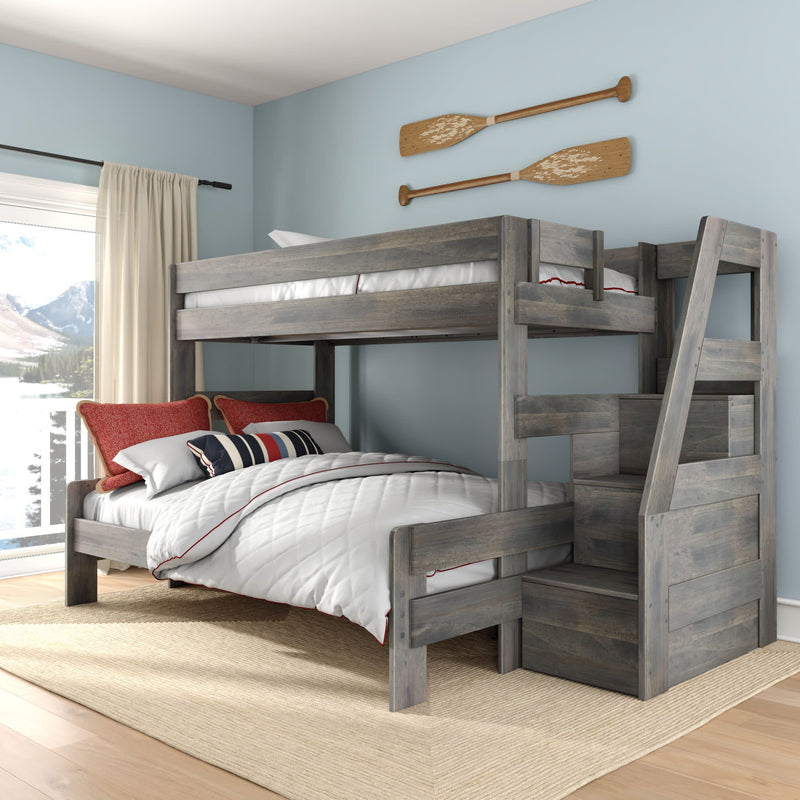 Gray rustic twin-over-full wooden bunk bed with staircase storage, white and red nautical bedding, light blue kids' bedroom with oar wall decor and mountain-view window