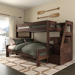 Dark walnut bunk bed with built-in storage staircase and green bedding in a cozy lake-view bedroom — space-saving wooden bedroom furniture