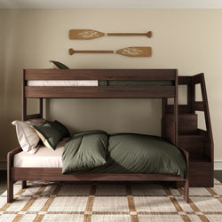 Dark walnut wooden bunk bed with built-in staircase, olive-green bedding and decorative oars on wall in a modern rustic bedroom