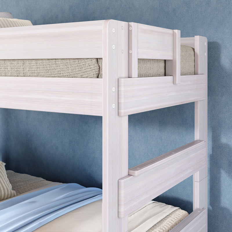 Close-up of whitewashed wooden bunk bed with safety rails and ladder, twin mattresses with blue bedding in a modern kids' room
