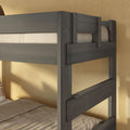 Close-up of gray wooden bunk bed frame and ladder with twin mattress and beige bedding in a modern bedroom
