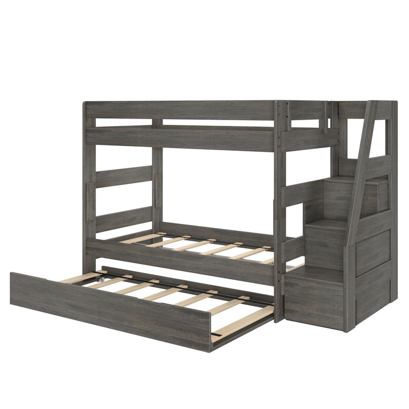 Gray wooden twin-over-full bunk bed with built-in staircase storage, pull-out trundle drawer and slatted mattress supports — space-saving kids bedroom furniture