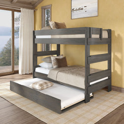 Gray wooden bunk bed with pull-out trundle mattress in cozy rustic bedroom, plaid pillows, large window and natural light