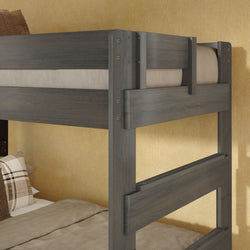 Modern gray wooden bunk bed frame with built-in ladder, beige bedding and plaid accent pillows against a textured yellow wall