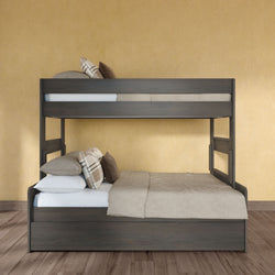 Dark wood bunk bed with full-size lower bed and twin top, beige bedding and plaid pillows on hardwood floor against a yellow textured wall