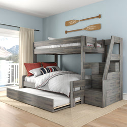 Gray wooden bunk bed with pull-out trundle and storage staircase in nautical-style kids' bedroom with blue walls and lake-view balcony