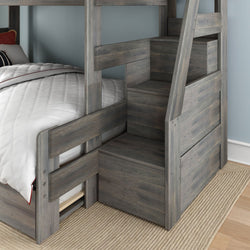 Gray wooden twin-over-twin bunk bed with storage staircase and under-bed drawers, white quilted bedding