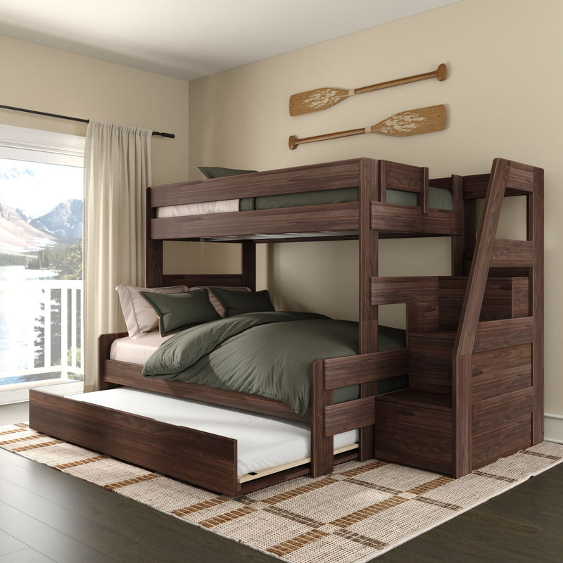 Dark walnut wooden bunk bed with pull-out trundle and storage staircase, green bedding in a modern lakeside bedroom with large window and decorative wooden oars on the wall