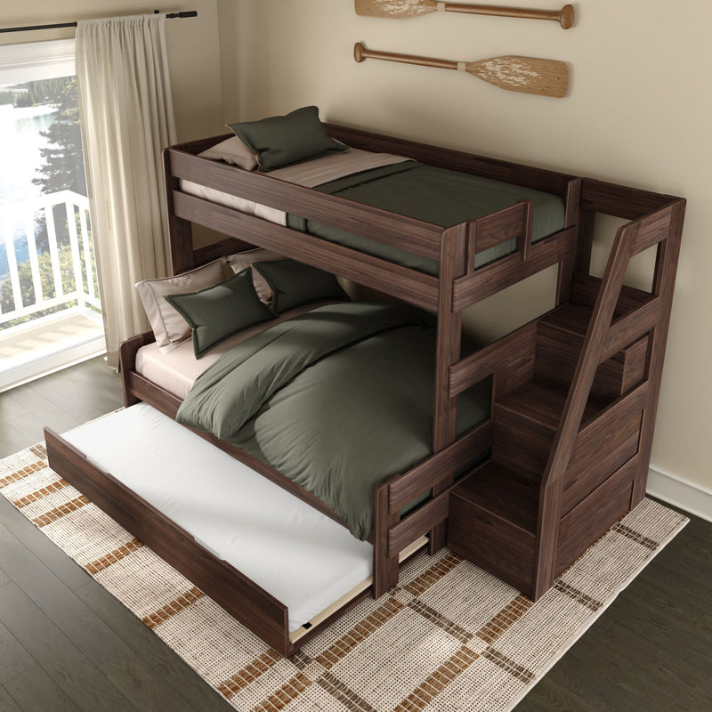 Dark walnut bunk bed with staircase storage and pull-out trundle, green bedding and pillows, woven rug in modern lakeside bedroom with balcony view