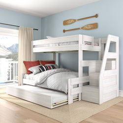 White wooden bunk bed with staircase and pull-out trundle, storage steps in a coastal-style bedroom with light blue walls, oar wall decor and lake view