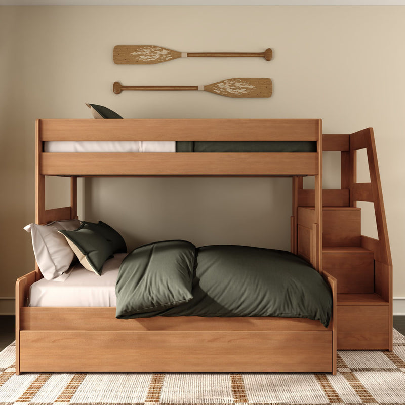Wooden twin-over-full bunk bed with built-in staircase, green bedding and nautical oar wall decor in a modern rustic kids bedroom.