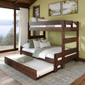 Dark walnut wooden bunk bed with pull-out trundle in a cozy lakeside bedroom, neutral bedding and green accent pillows, large window with forest and lake view