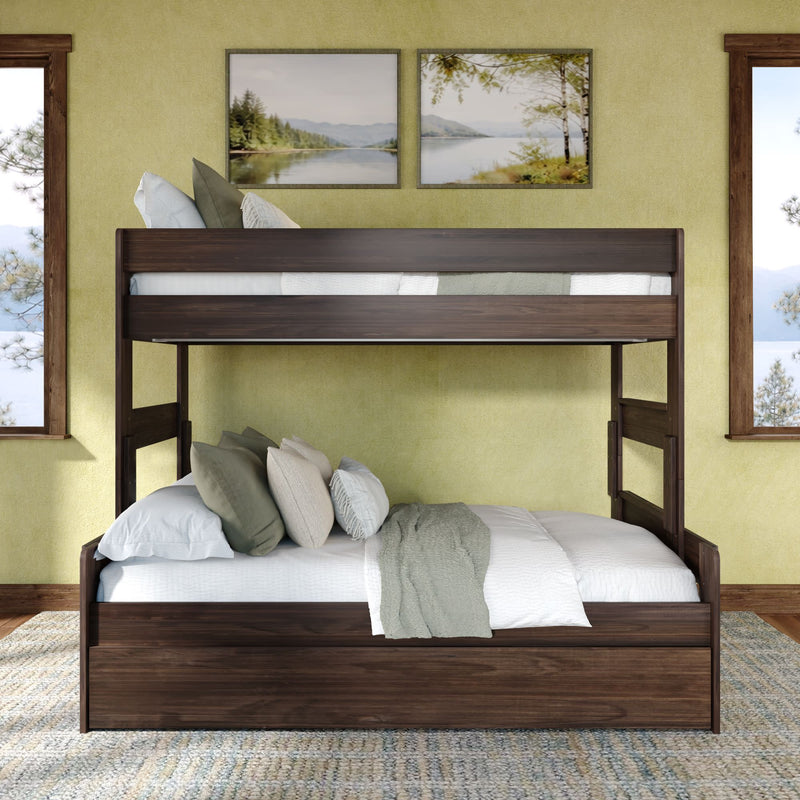 Dark walnut twin-over-full wooden bunk bed with trundle drawer, white and sage bedding and accent pillows in a sunlit rustic bedroom with lake landscape wall art