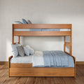 Modern solid wood bunk bed with blue-gray bedding and decorative pillows in a minimalist, space-saving bedroom on hardwood floors